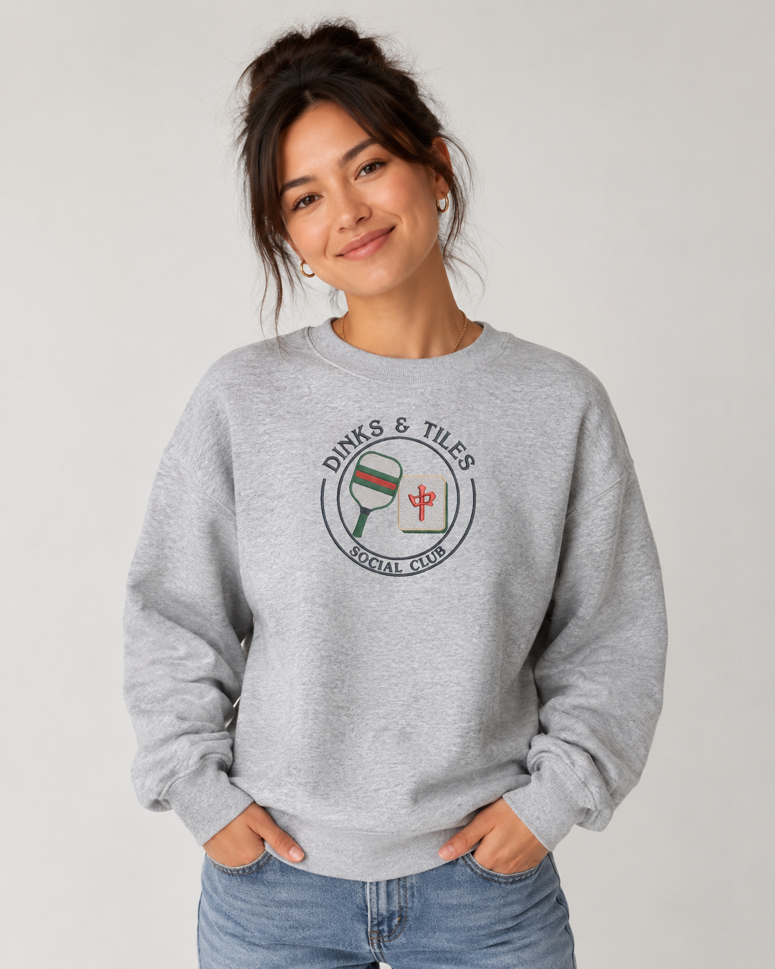 Dinks & Tiles Social Club crewneck sweatshirt featuring pickleball paddle and mahjong tile graphic on center chest.